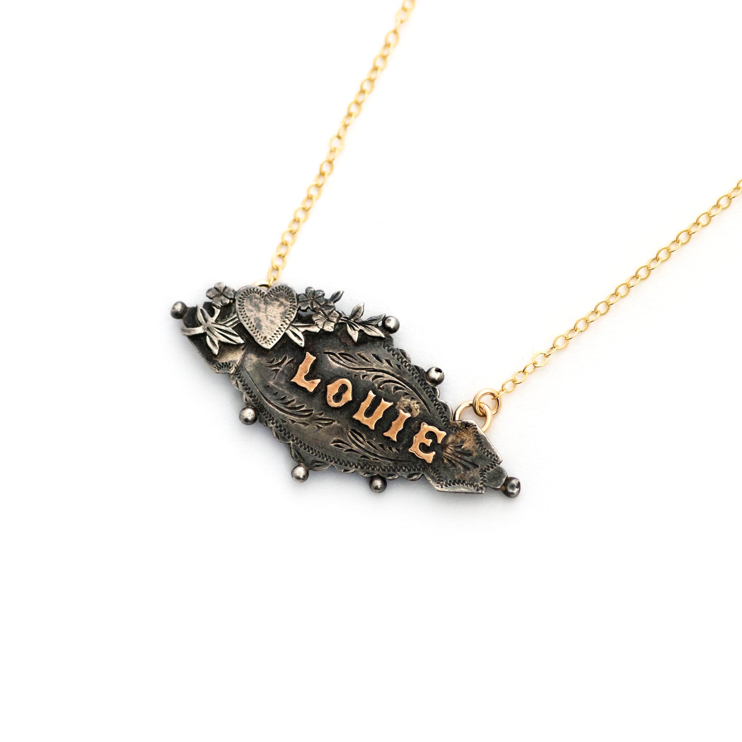 Sterling silver Victorian brooch pendant from the late 1800s with hand tooled details and gold filled letters spelling "LOUIE".