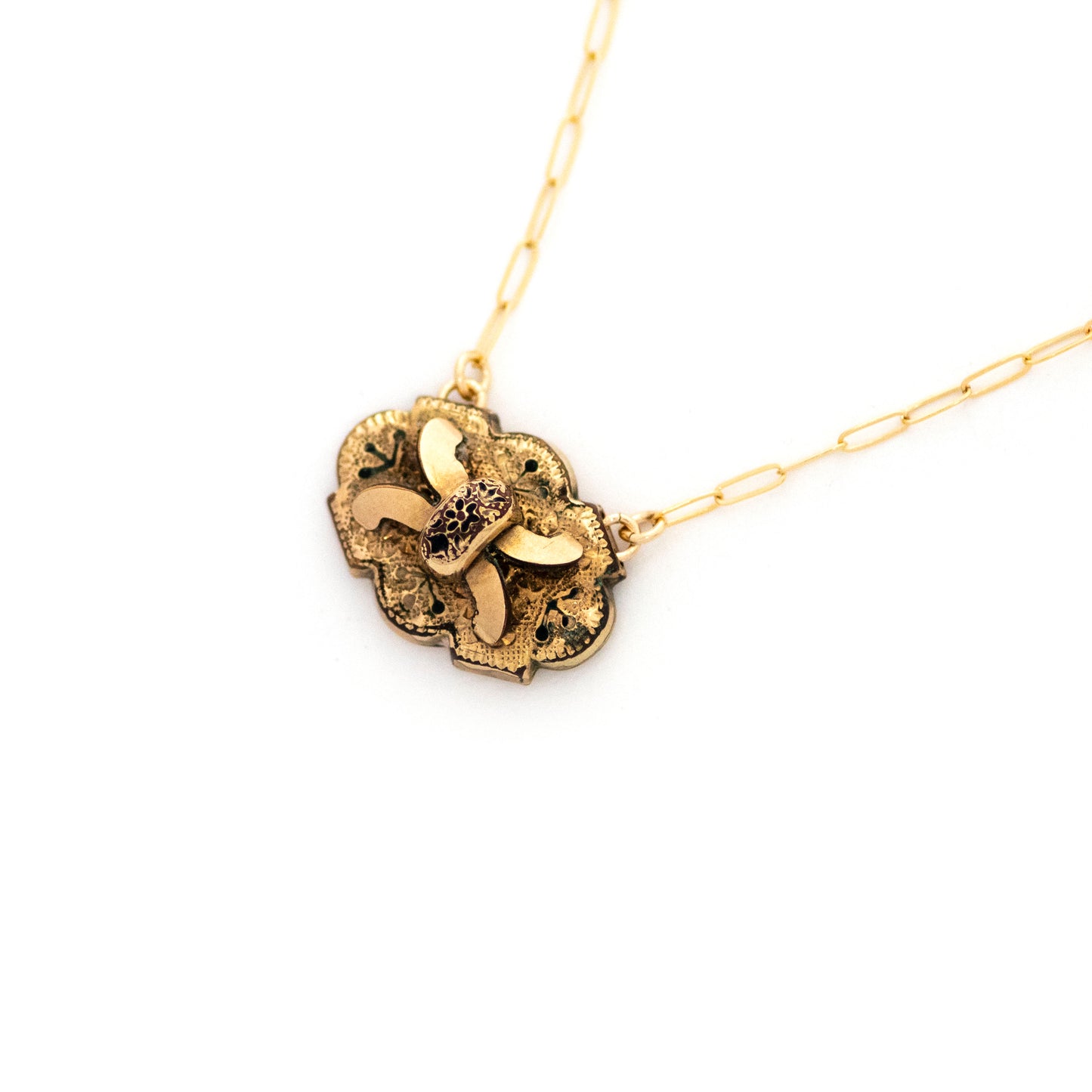 Gold filled Victorian brooch pendant from the late 1800s with hand tooled details, black enamel tracery (taille d'epargne) and an X-shaped buckle motif.
