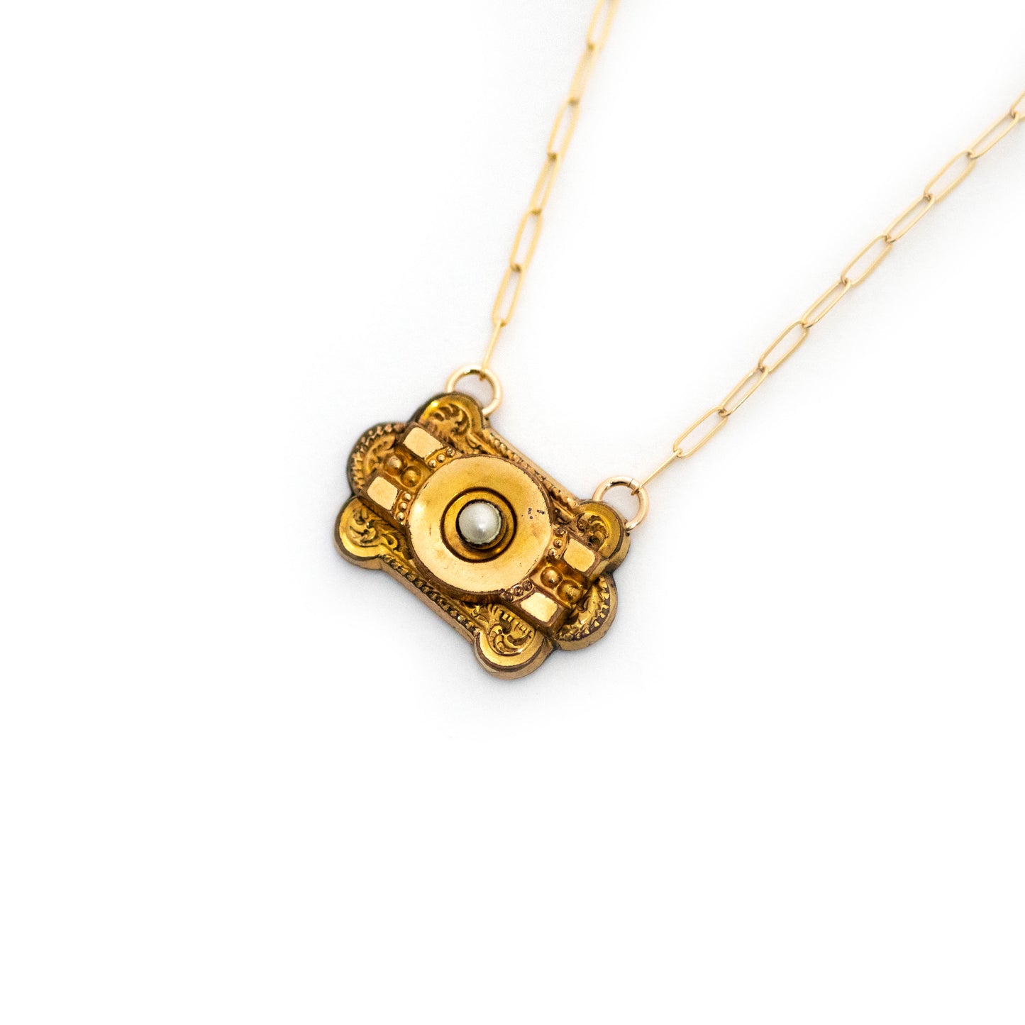 This one-of-a-kind conversion necklace is made up of: Gold filled Victorian brooch pendant from the late 1800s with hand tooled details and a genuine seed pearl