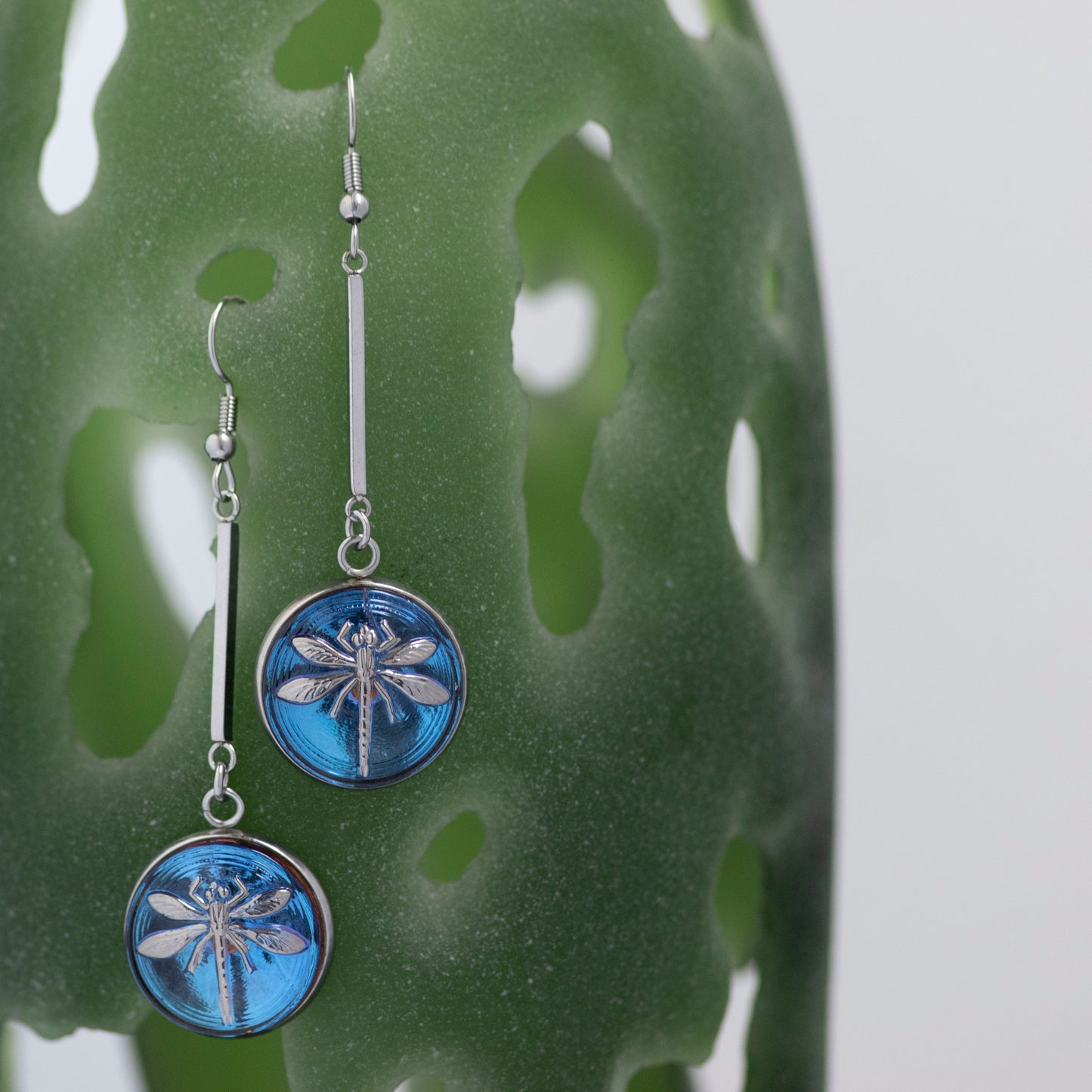Blue and platinum painted Czech glass button drop dangle earrings.