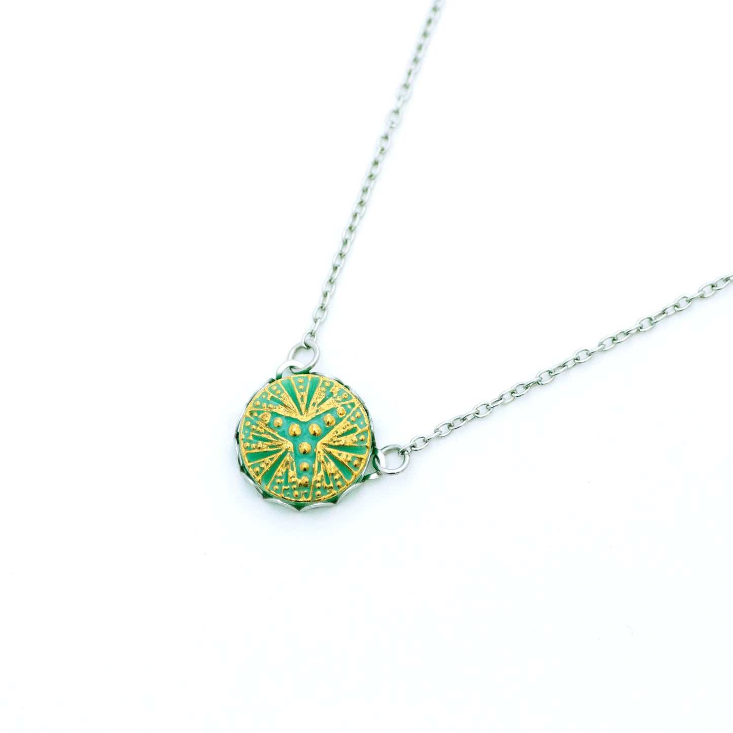 Light turquoise Czech glass button with three point bursting star. Button pendant necklace. Uranium glass button contains 2% uranium dioxide. This small amount in the glass allows it to fluoresce (glow) green under a black light and is also safe to wear.