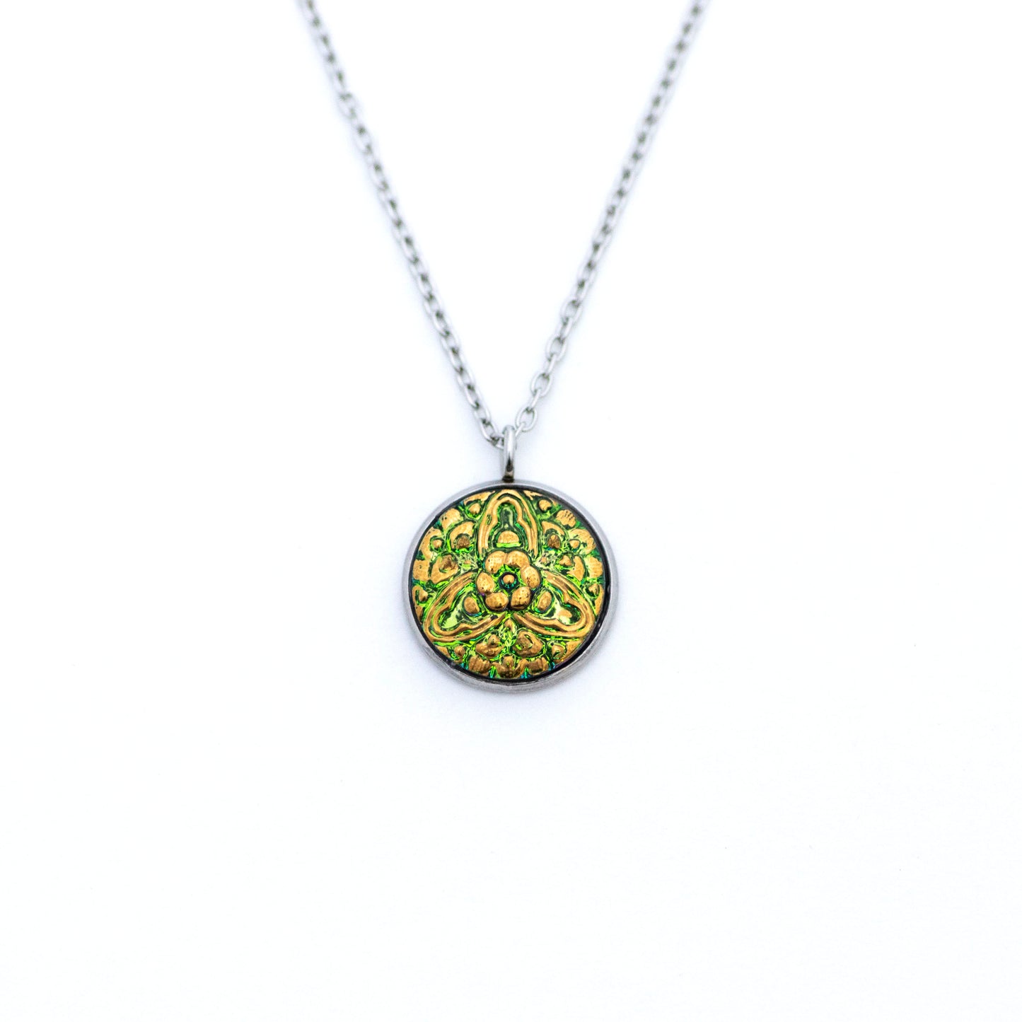 Green and gold painted Czech glass button with 3 point floral motif. Button pendant necklace.
