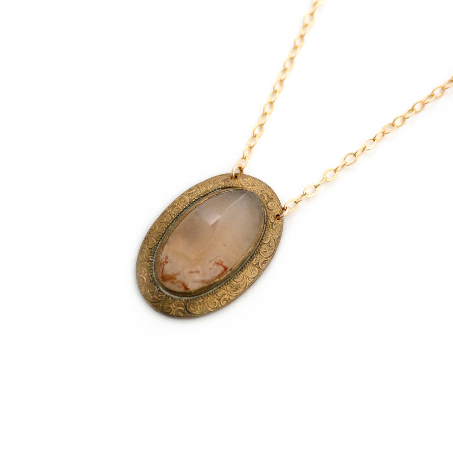 Gold filled Victorian brooch pendant from the late 1800s with hand tooled details, featuring a slab of red moss agate that is full of mystery.