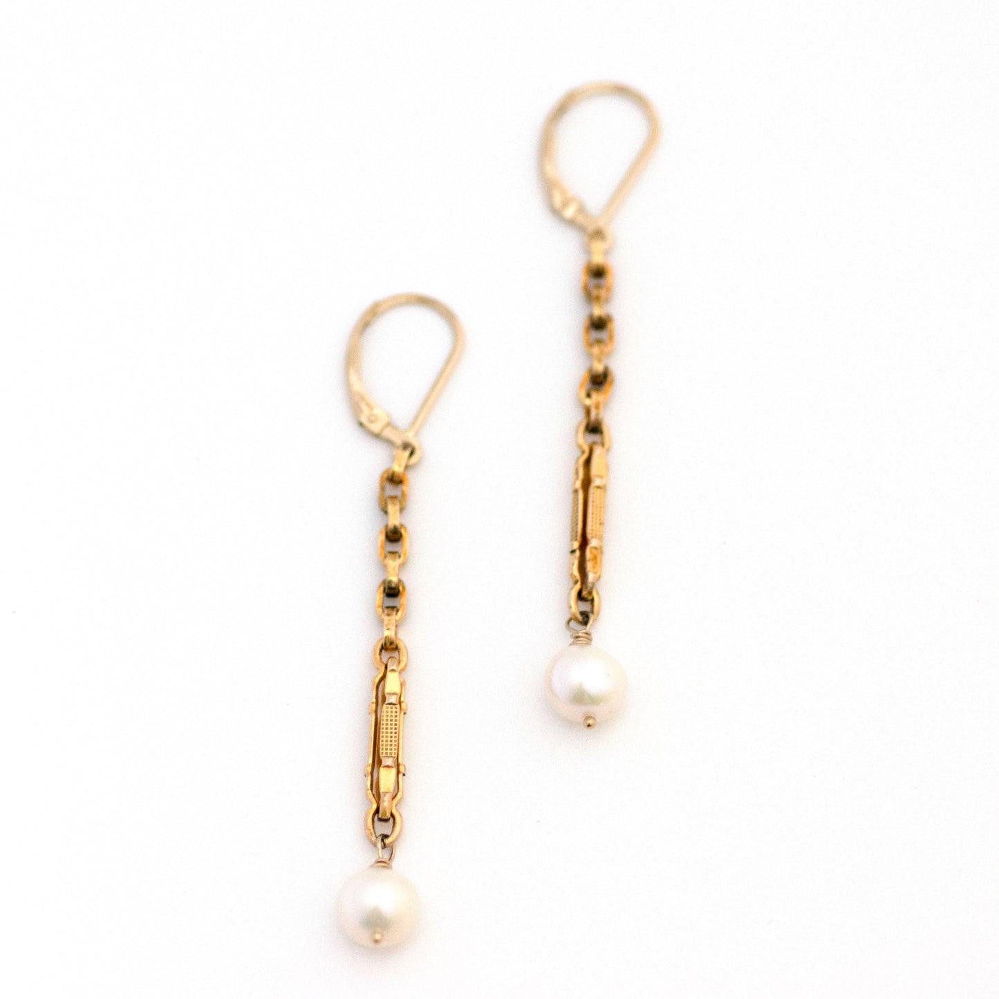 This one-of-a-kind conversion necklace is made up of: Gold filled Edwardian watch chain links from the early 1900s with dangling freshwater pearls.