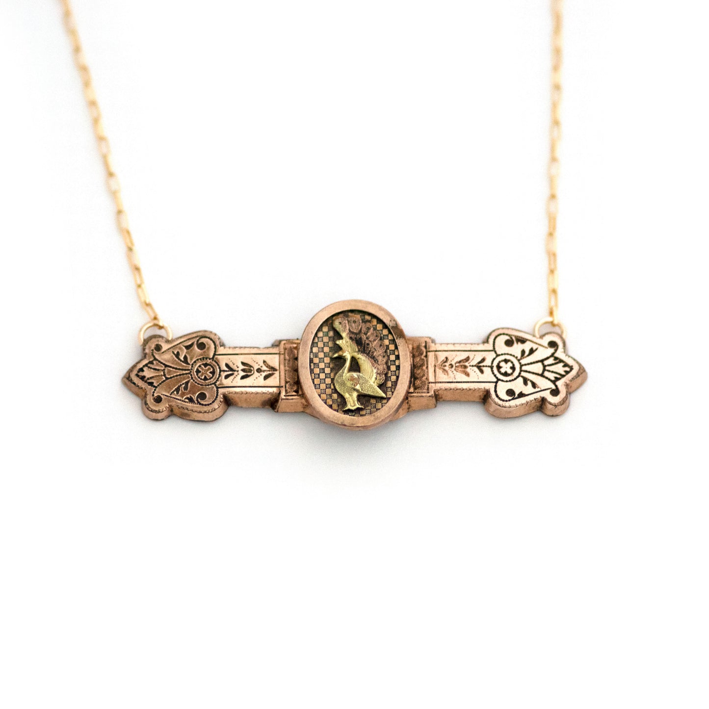 This one-of-a-kind conversion necklace is made up of: Gold filled Victorian bar pin pendant from the late 1800s with peacock in profile on a checkerboard pattern backsplash.
