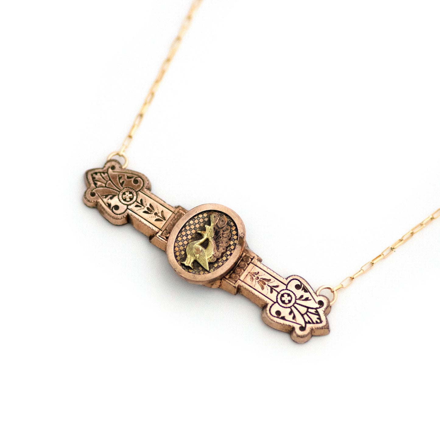 This one-of-a-kind conversion necklace is made up of: Gold filled Victorian bar pin pendant from the late 1800s with peacock in profile on a checkerboard pattern backsplash.