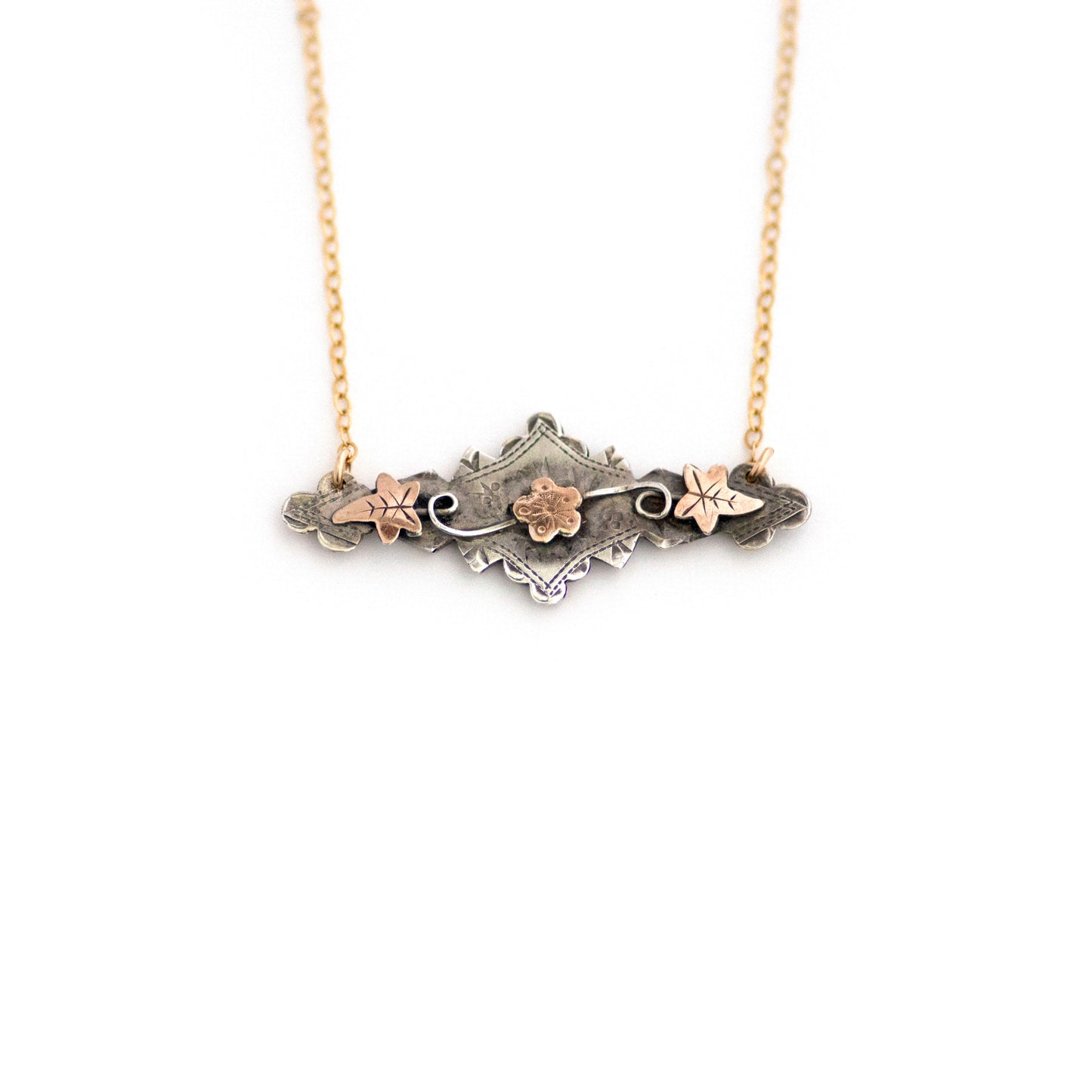This one-of-a-kind conversion necklace is made up of: Sterling silver and gold filled Victorian bar pin pendant from the late 1800s with hand tooled details including floral, vine and leaves accents.