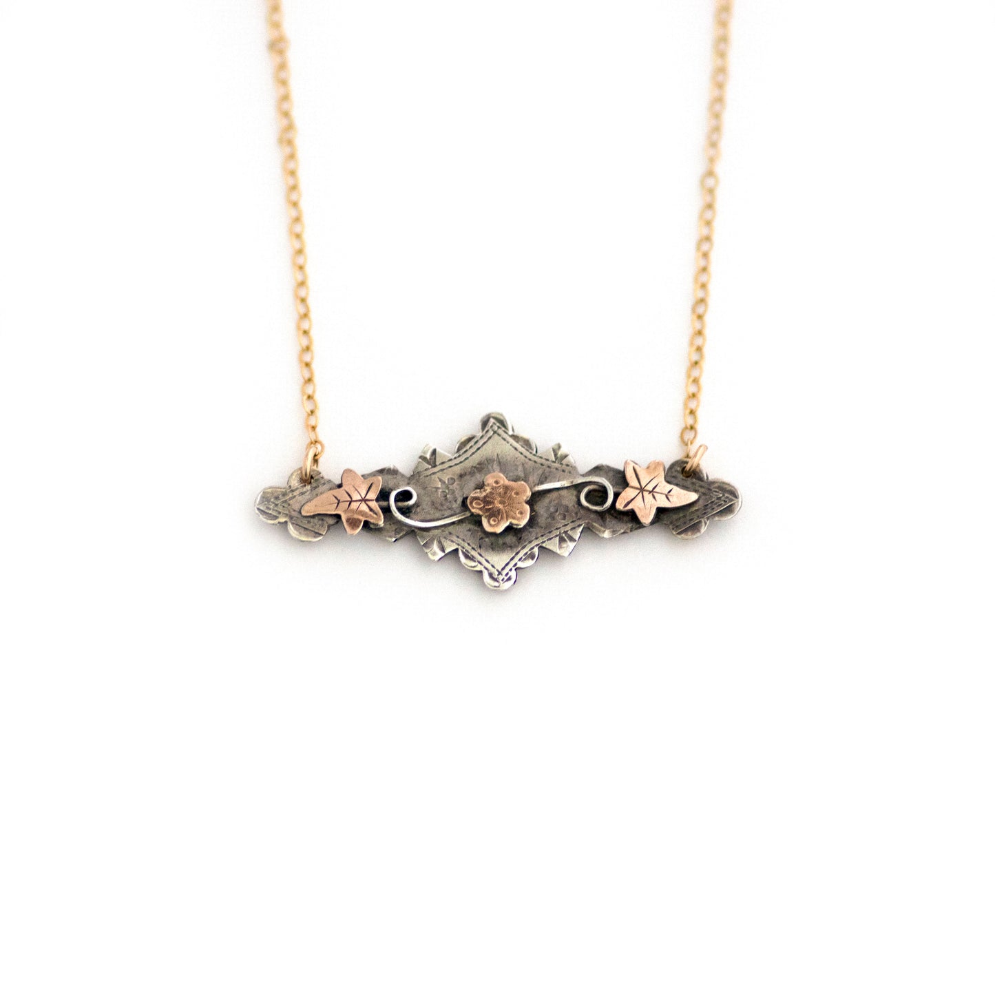 This one-of-a-kind conversion necklace is made up of: Sterling silver and gold filled Victorian bar pin pendant from the late 1800s with hand tooled details including floral, vine and leaves accents.