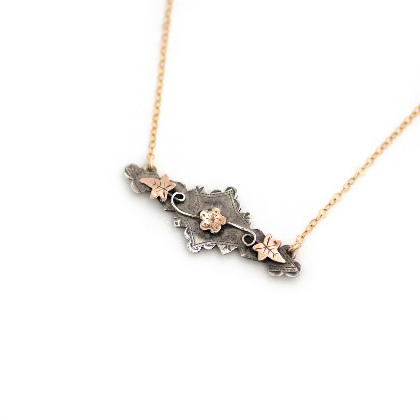 This one-of-a-kind conversion necklace is made up of: Sterling silver and gold filled Victorian bar pin pendant from the late 1800s with hand tooled details including floral, vine and leaves accents.