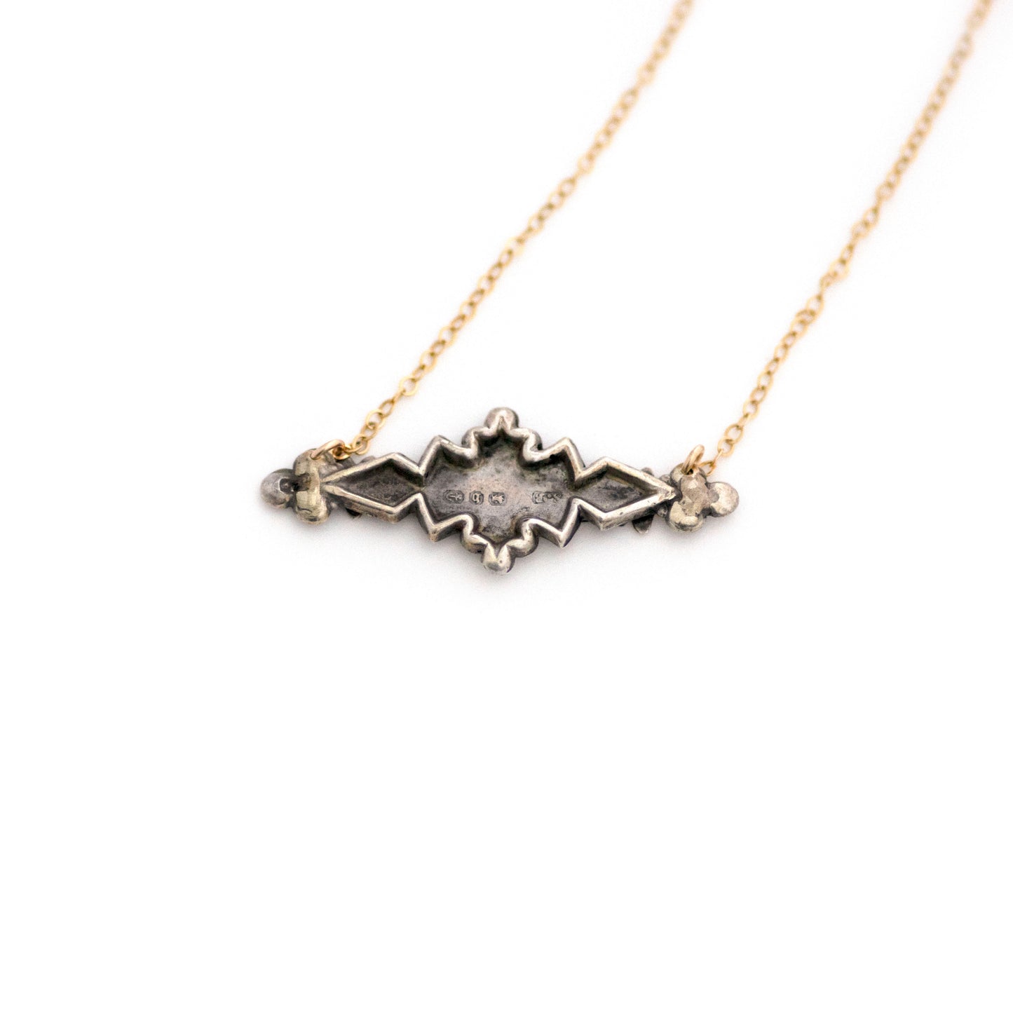 This one-of-a-kind conversion necklace is made up of: Sterling silver and gold filled Victorian bar pin pendant from the late 1800s with hand tooled details including floral, vine and leaves accents. Original English Birmingham hallmarks on the back.
