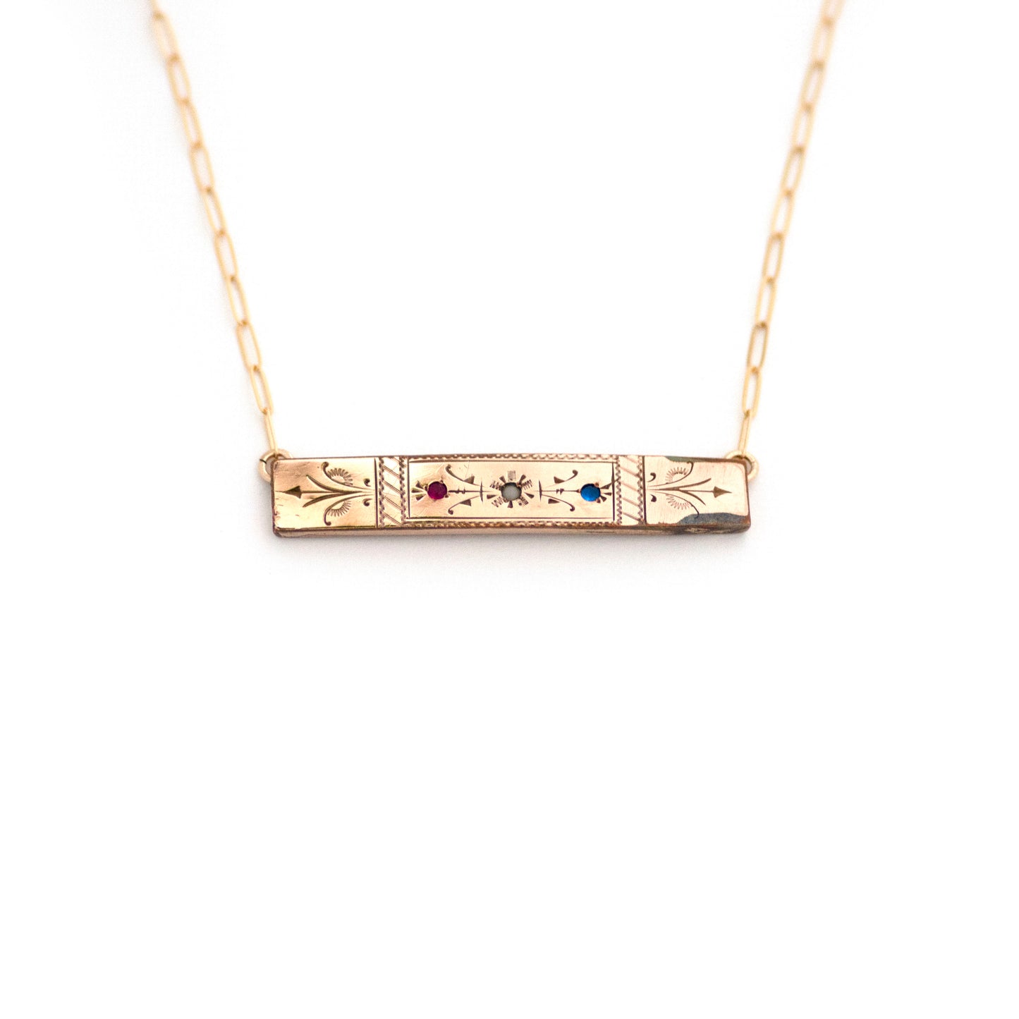 This one-of-a-kind conversion necklace is made up of: Gold filled Victorian bar pin pendant from the late 1800s with hand tooled details and red, white and blue glass accents.