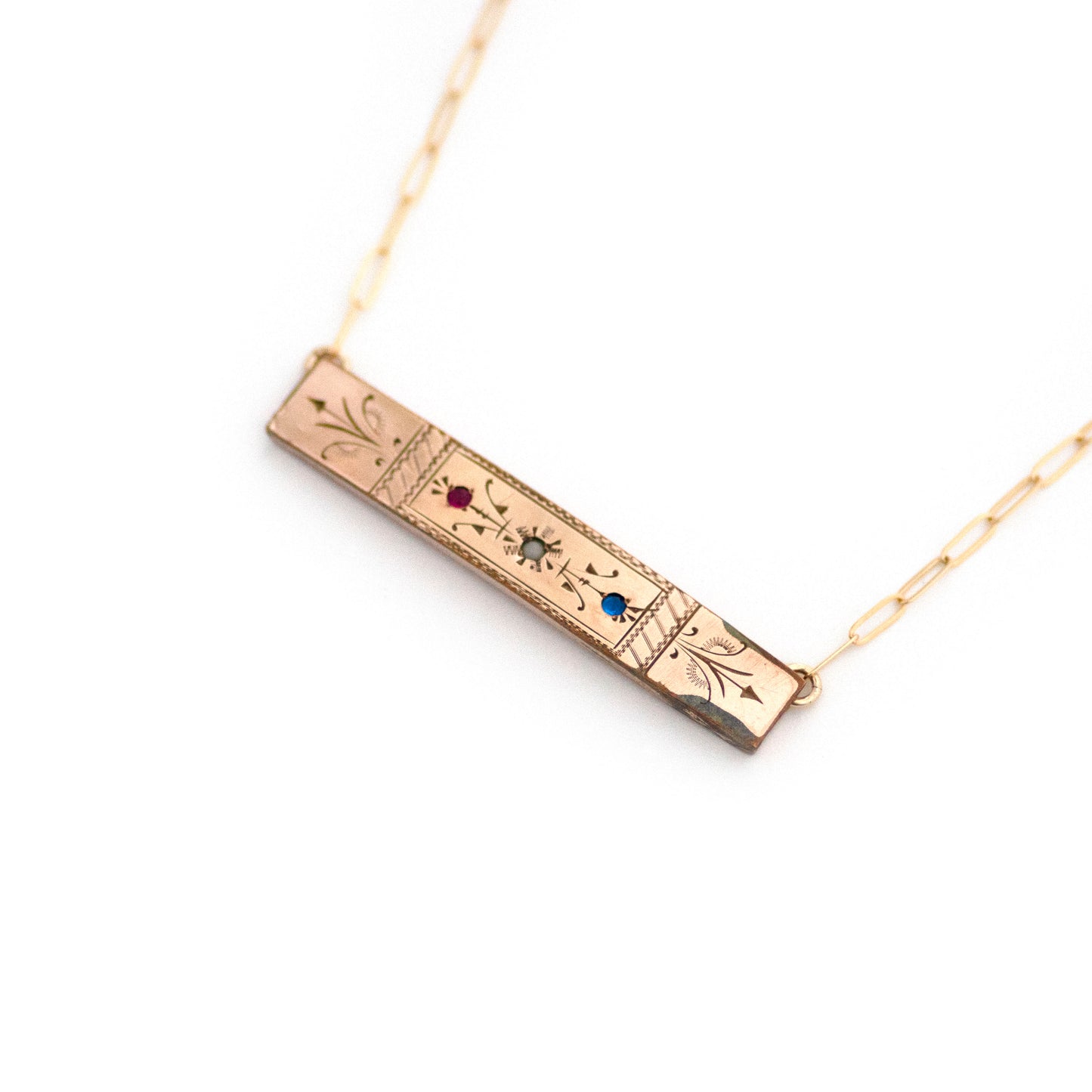 This one-of-a-kind conversion necklace is made up of: Gold filled Victorian bar pin pendant from the late 1800s with hand tooled details and red, white and blue glass accents.