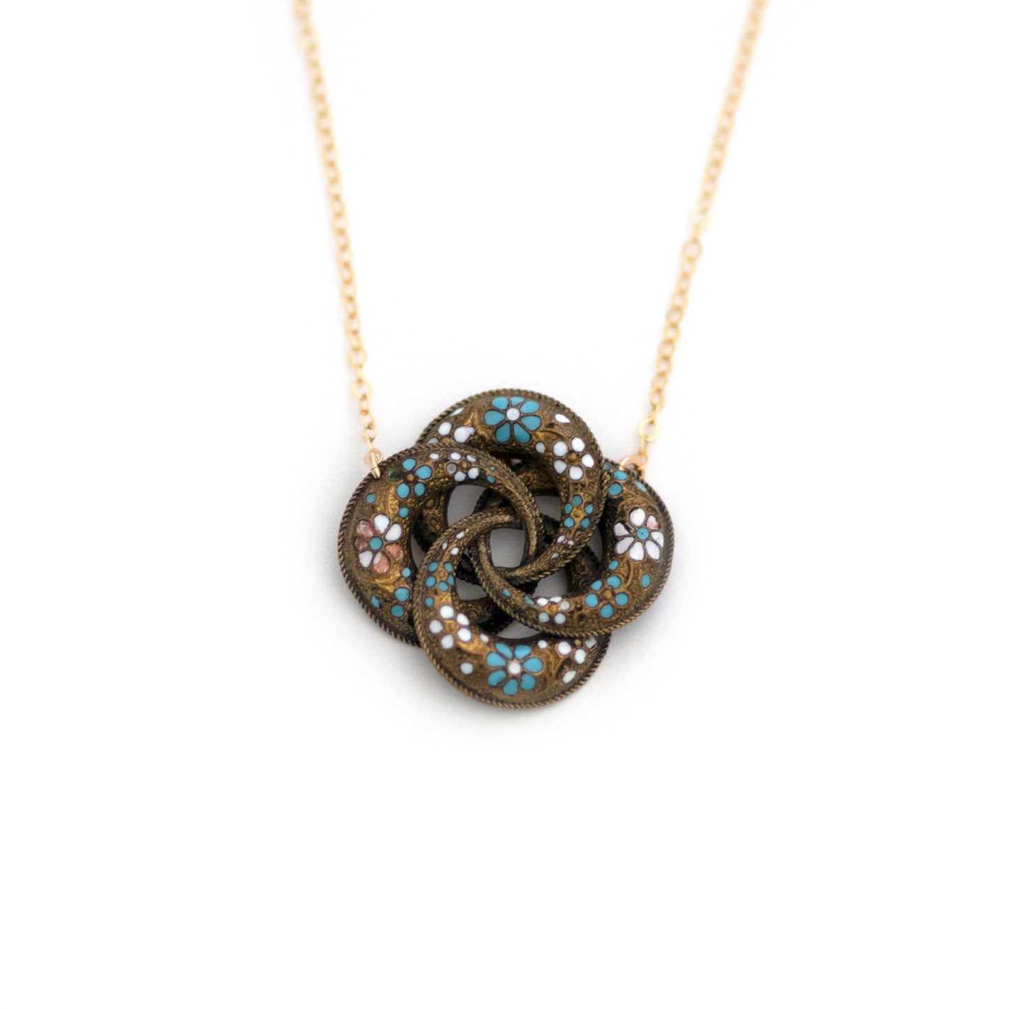 This one-of-a-kind conversion necklace is made up of: Brass Victorian brooch pendant from the late 1800s with blue and white enamel flowers.