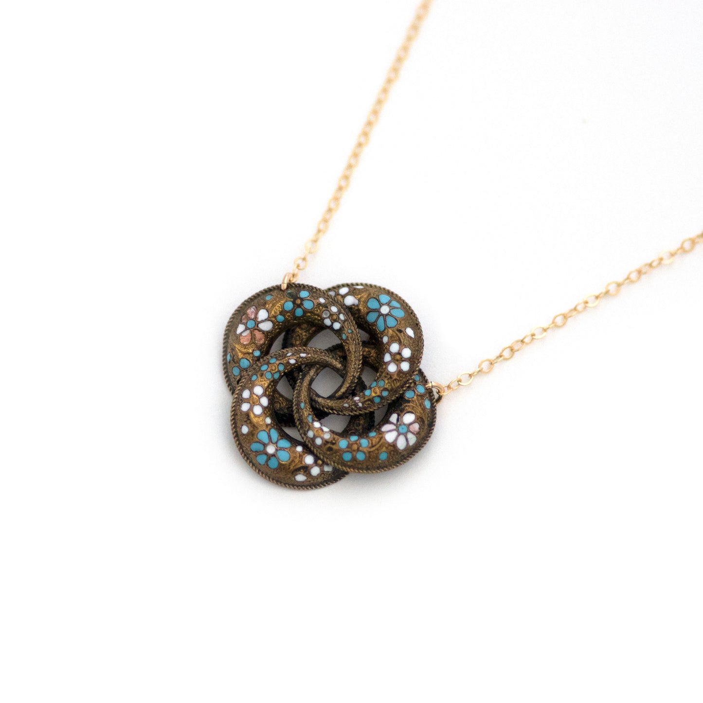 This one-of-a-kind conversion necklace is made up of: Brass Victorian brooch pendant from the late 1800s with blue and white enamel flowers.