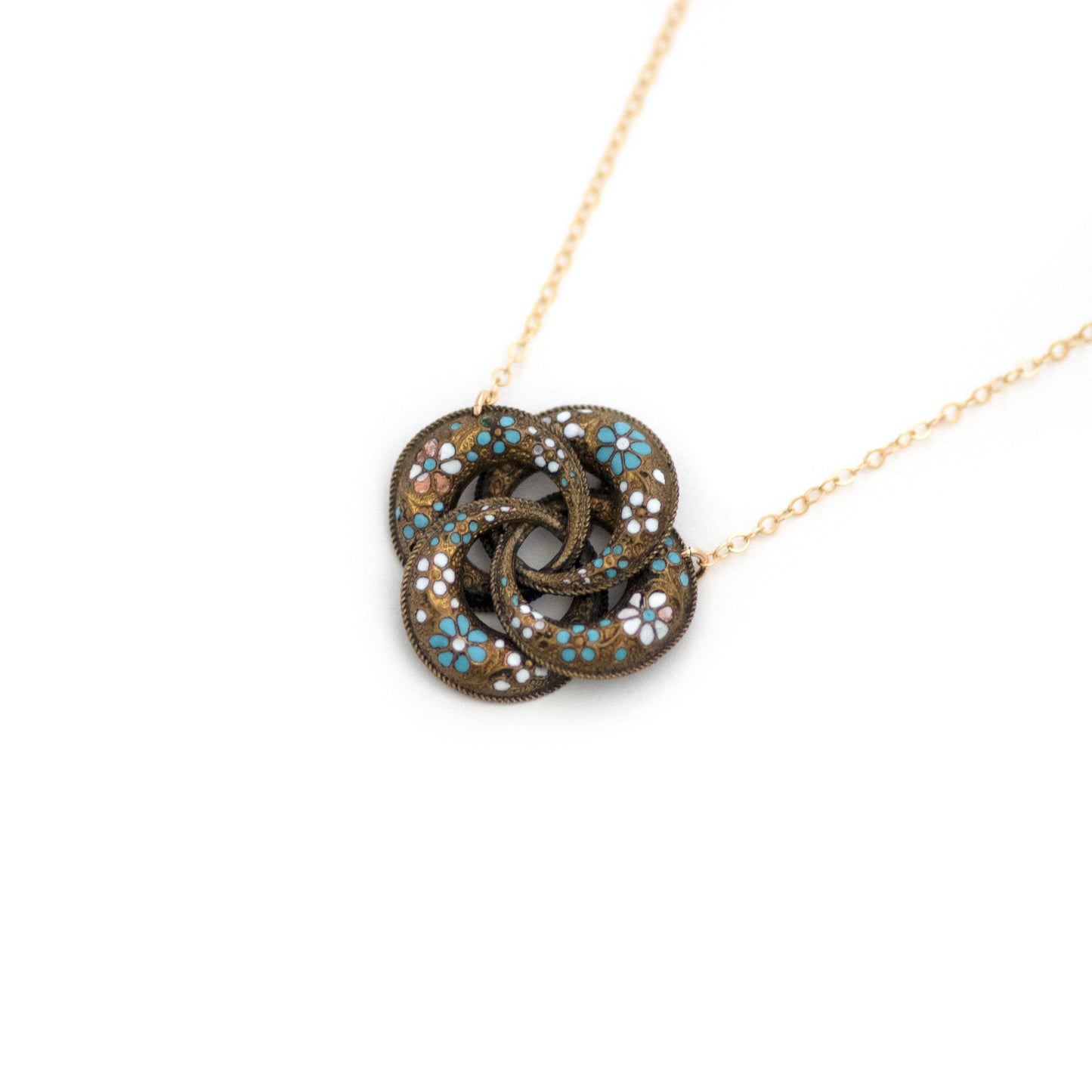This one-of-a-kind conversion necklace is made up of: Brass Victorian brooch pendant from the late 1800s with blue and white enamel flowers.