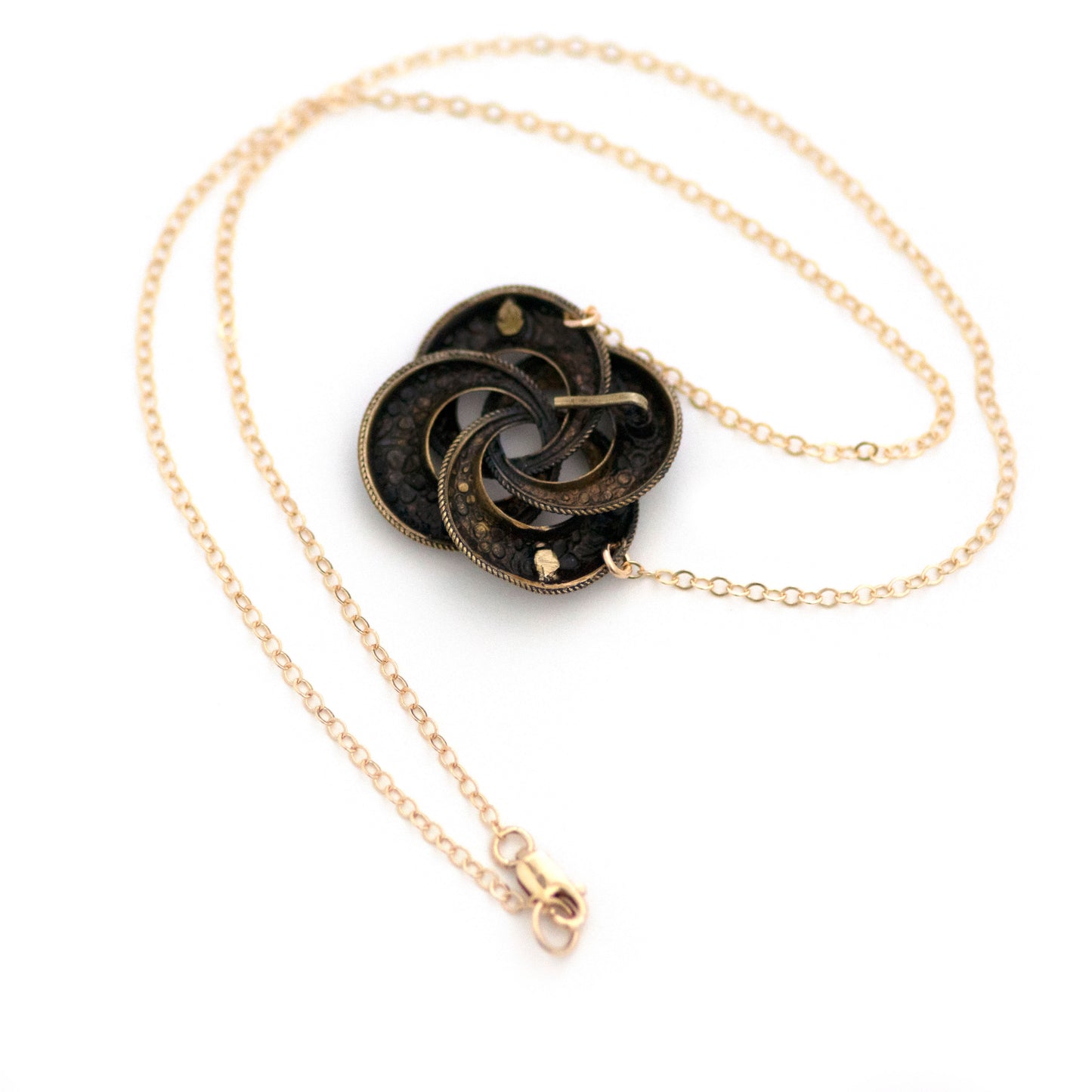 This one-of-a-kind conversion necklace is made up of: Brass Victorian brooch pendant from the late 1800s with blue and white enamel flowers.