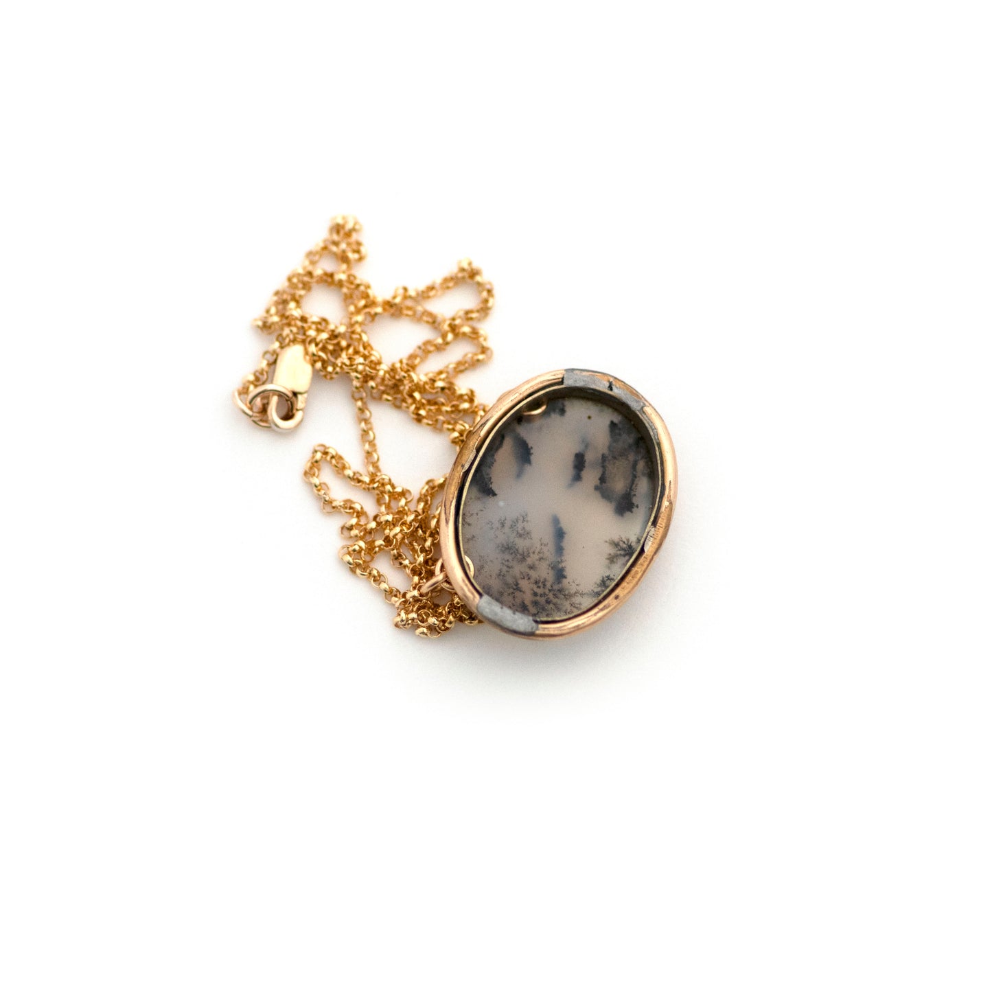 The back of a one-of-a-kind conversion necklace is made up of: Gold filled Victorian brooch pendant from the late 1800s with dendritic moss agate.