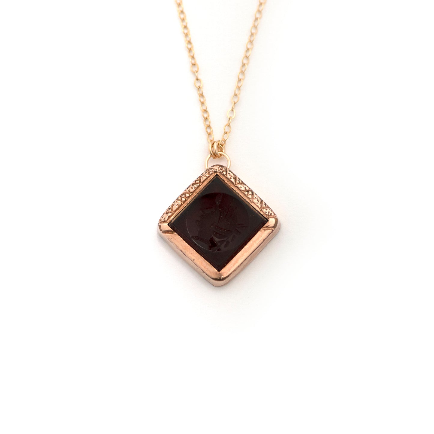 This antique conversion necklace is made up of: Gold filled Victorian cufflink from the late 1800s with a carnelian intaglio of a soldier, hanging from a 14k gold filled chain.