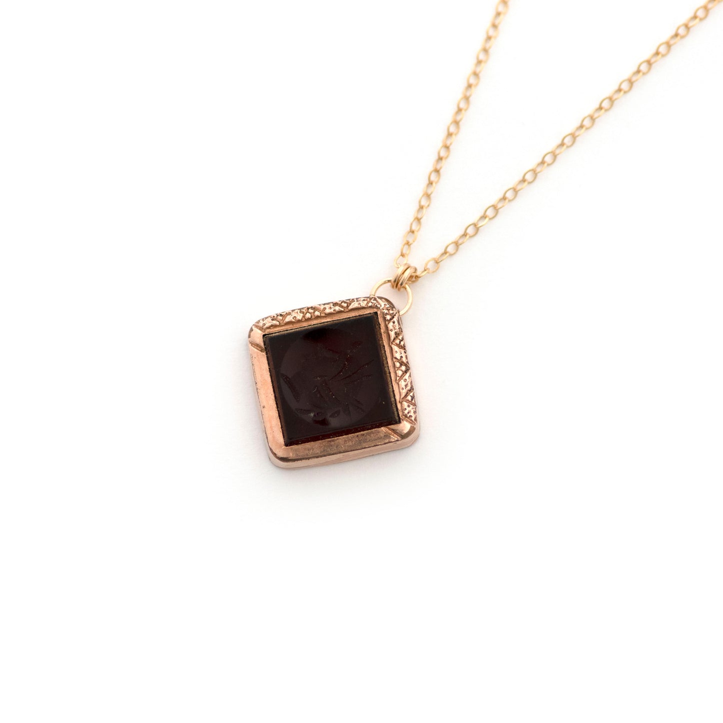 This antique conversion necklace is made up of: Gold filled Victorian cufflink from the late 1800s with a carnelian intaglio of a soldier, hanging from a 14k gold filled chain.