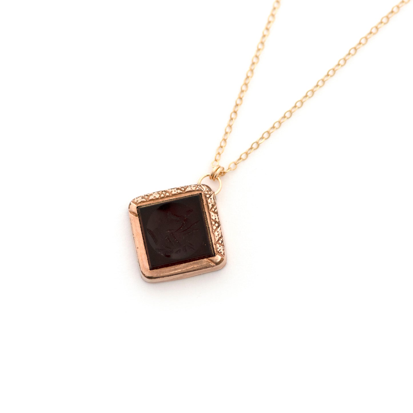 This antique conversion necklace is made up of: Gold filled Victorian cufflink from the late 1800s with a carnelian intaglio of a soldier, hanging from a 14k gold filled chain.