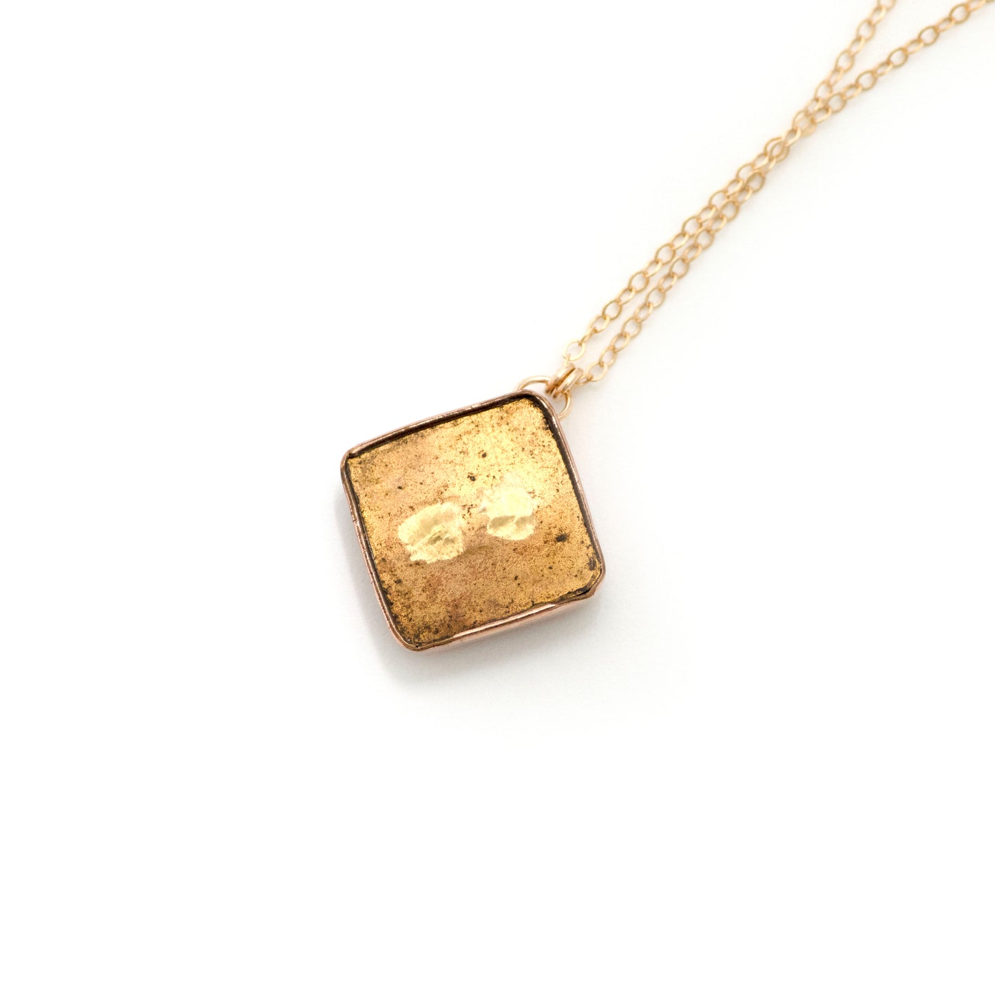 the back of an antique conversion necklace is made up of: Gold filled Victorian cufflink from the late 1800s with a carnelian intaglio of a soldier, hanging from a 14k gold filled chain.