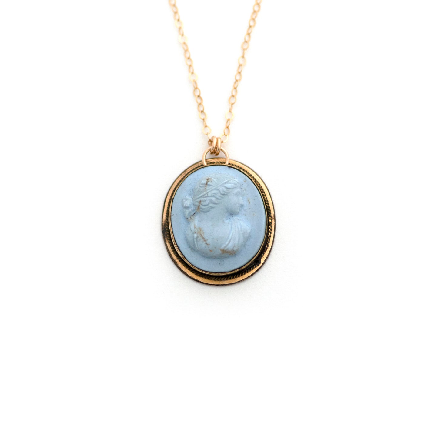 This antique conversion necklace is made up of:  Gold filled Victorian cuff link from the late 1800s with a pale blue porcelain cameo on a 14k gold filled chain.