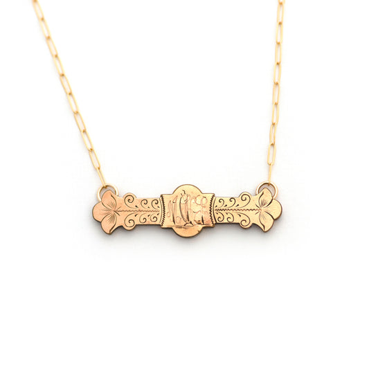 This antique conversion necklace is made up of:  Gold filled Victorian bar pin pendant from the late 1800s with hand engraved  details. Initials of MKE or MEK appear to be engraved over a landscape scene with a ship sailing over the open water and into the sunset.
