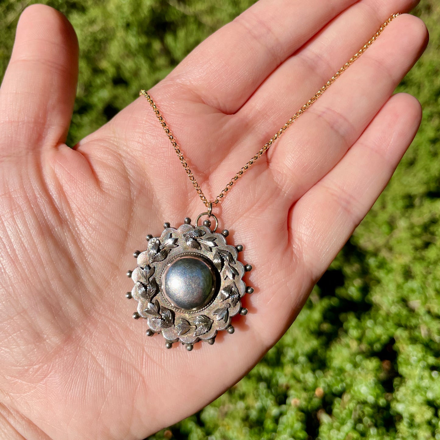 Antique Victorian Sterling Leaves Brooch Necklace held in the palm of the hand