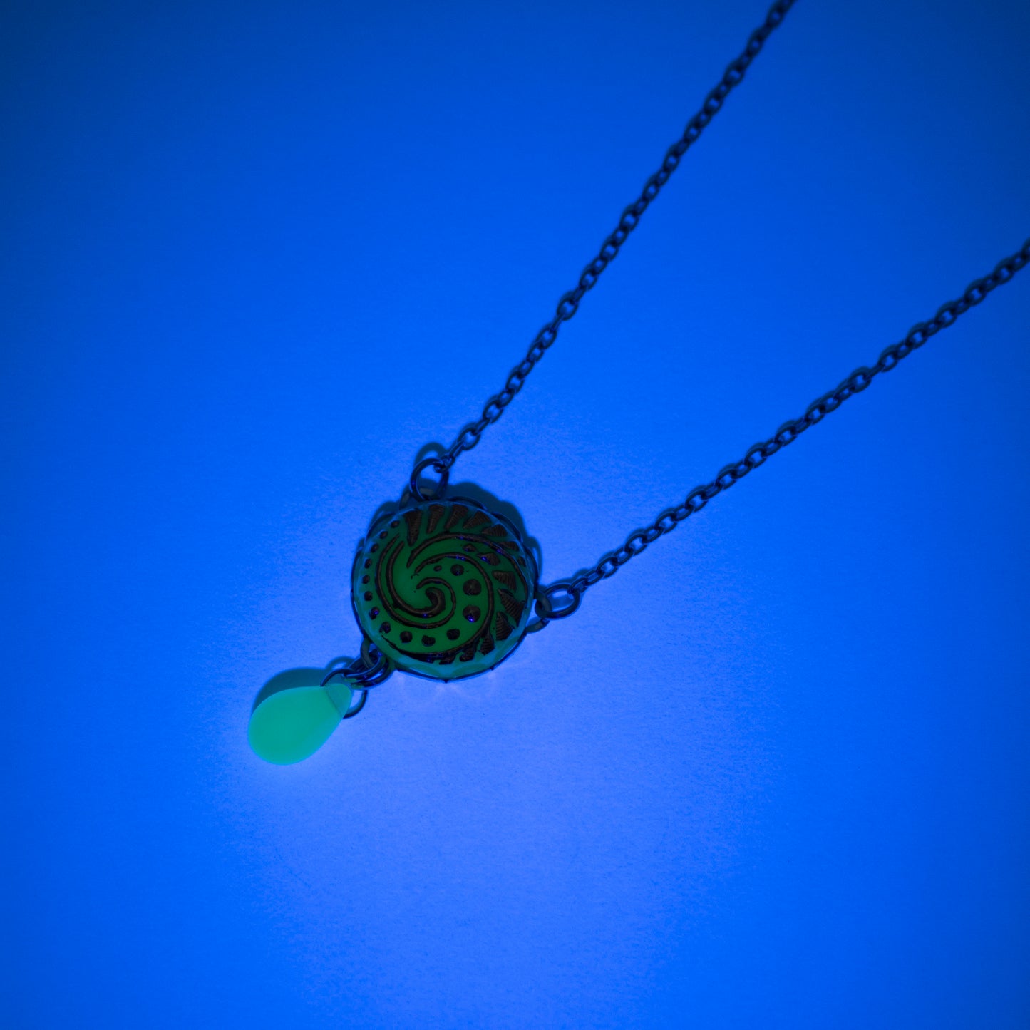 Button pendant necklace. Uranium glass button in light turquoise color.  Uranium glass button contains 2% uranium dioxide. This small amount in the glass allows it to fluoresce (glow) green under a black light and is also safe to wear.