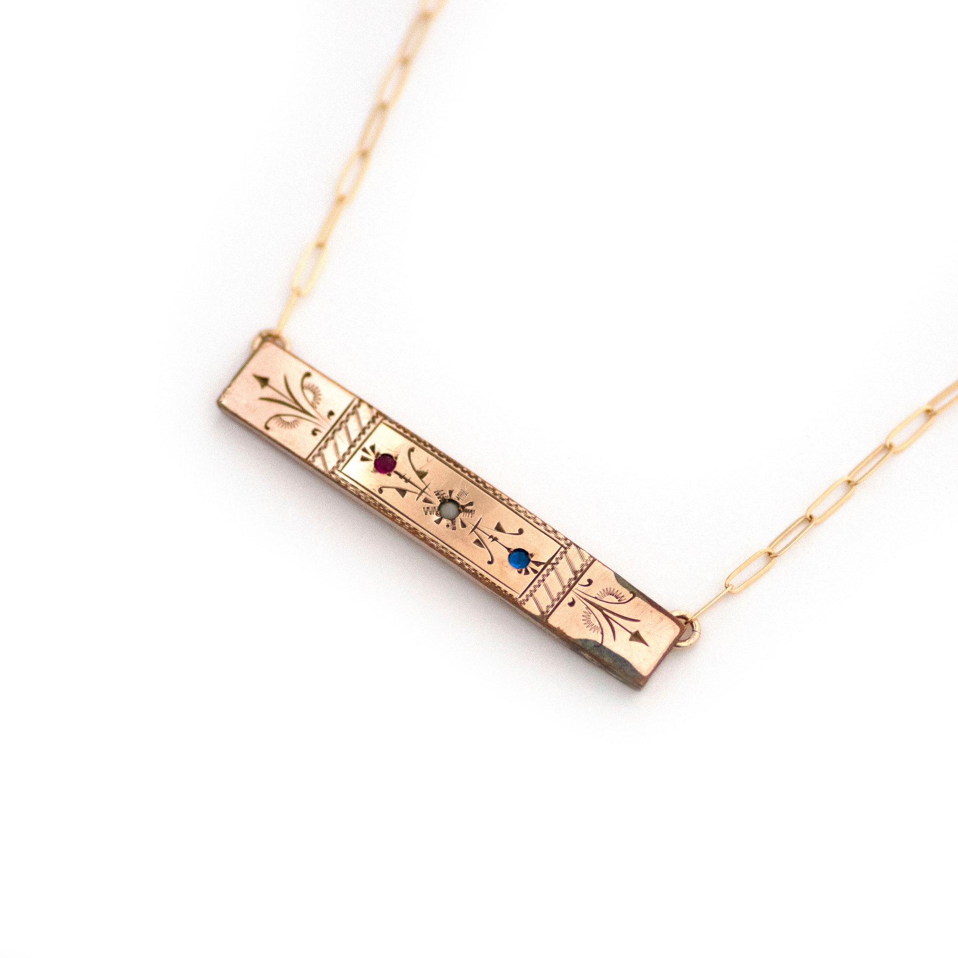 This one-of-a-kind conversion necklace is made up of:  Gold filled Victorian bar pin pendant from the late 1800s with hand tooled details and red, white and blue glass accents.