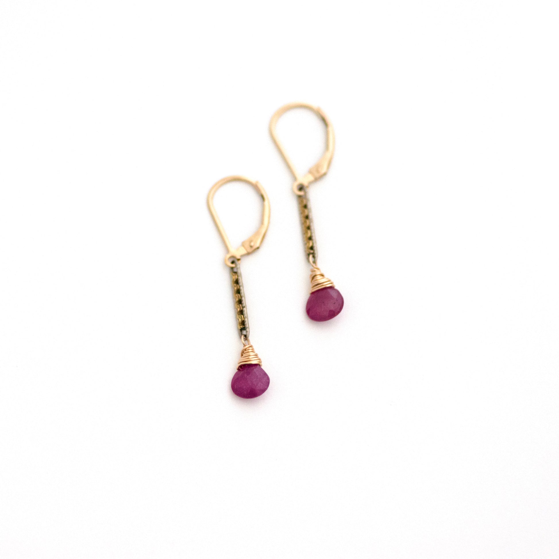 These antique conversion earrings are made up of:  Gold filled and silver tone Edwardian watch chain links from the early 1900s with hand tooled details. Ruby.