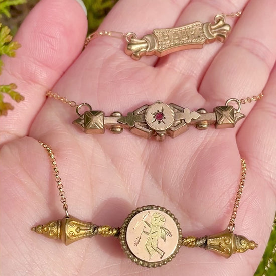 video of Red Paste Edwardian Bar Pin Necklace and 2 other antique bar pin necklaces in palm of hand
