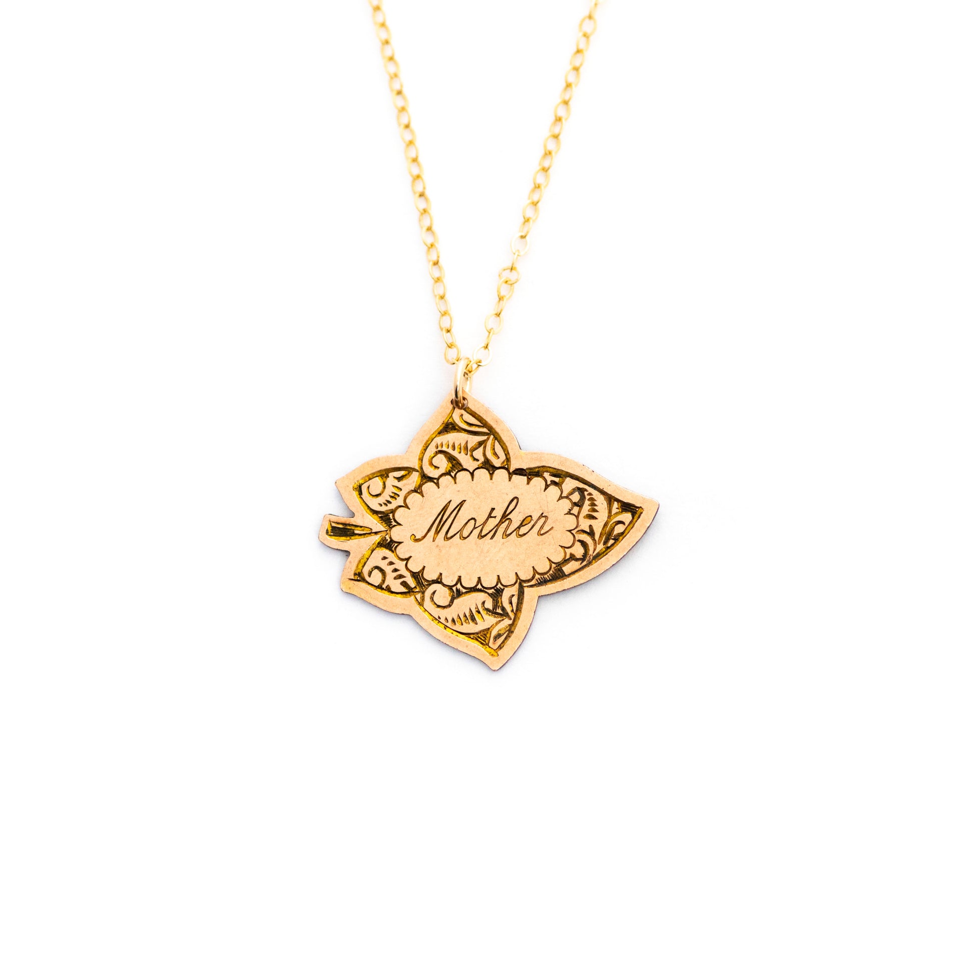 This antique conversion necklace is made up of:  Gold filled Victorian brooch pendant from the late 1800s with hand tooled details. Pendant is in the shape of a leaf and engraved with the word "Mother". 
