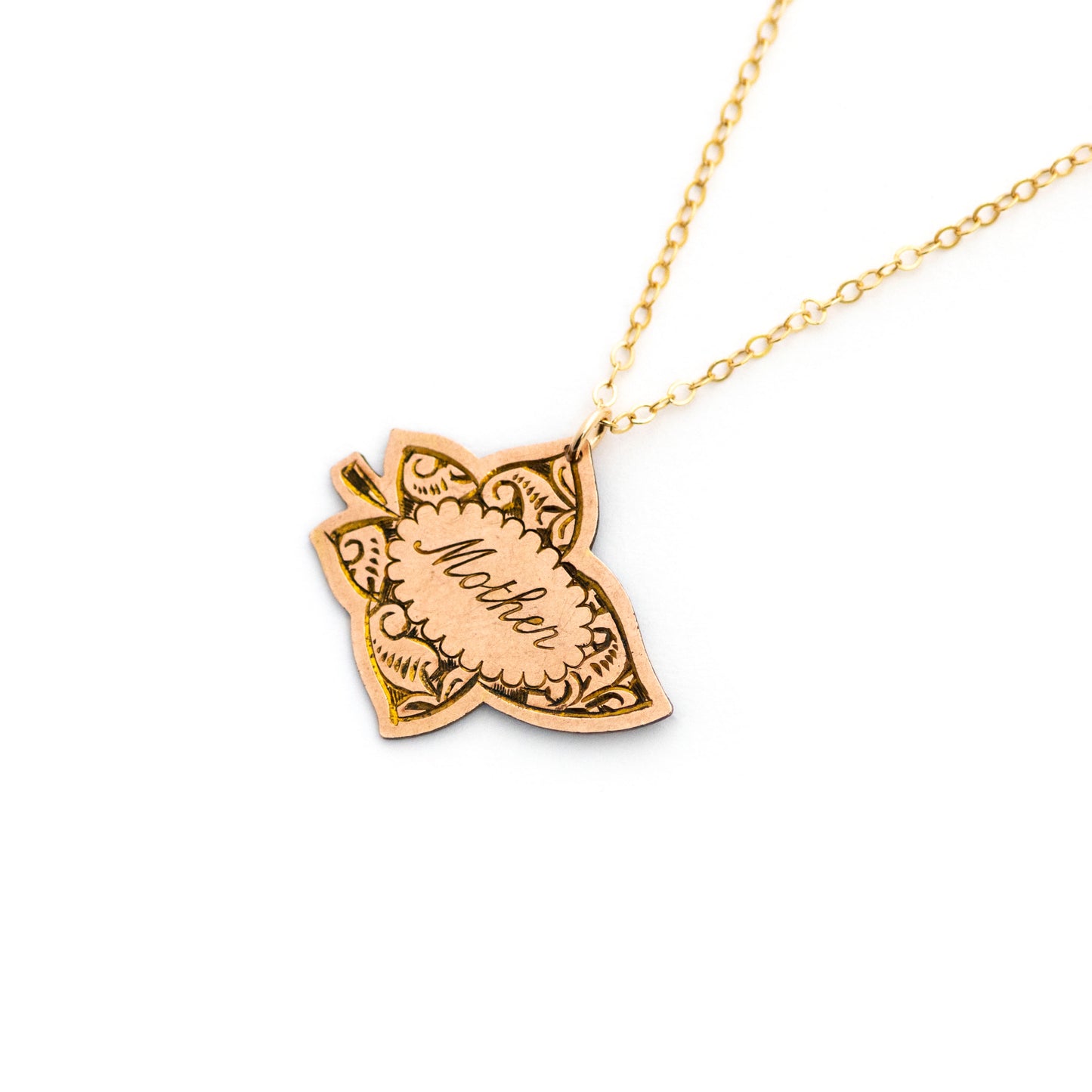 This antique conversion necklace is made up of:  Gold filled Victorian brooch pendant from the late 1800s with hand tooled details. Pendant is in the shape of a leaf and engraved with the word "Mother". Hanging on a simple 14k gold filled chain.