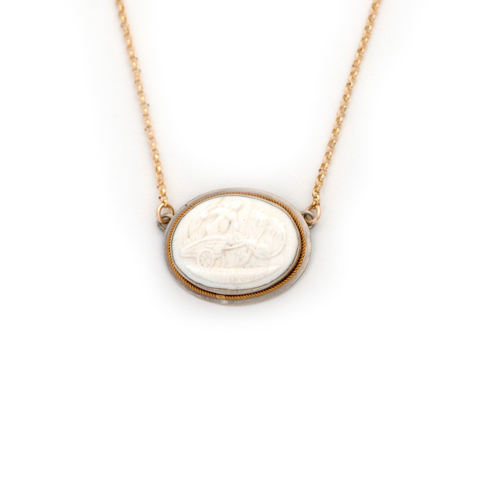 This antique necklace is made up of:  Sterling Silver Victorian pendant from the late 1800s with a twisted gold border and cream white porcelain cameo. Cameo depicts the Greek goddess of love, Aphrodite, riding a chariot drawn by a pair of doves. Doves are a prominent symbol of hers, as are the planet Venus and the Spring month of April. Friday is the day of Venus. 