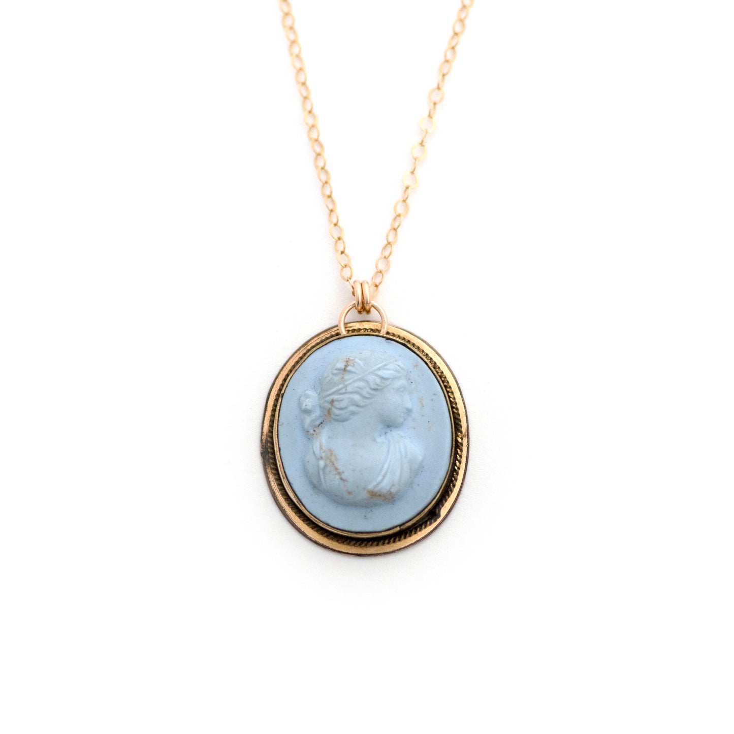 This antique conversion necklace is made up of:  Gold filled Victorian cuff link from the late 1800s with a pale blue porcelain cameo on a 14k gold filled chain.