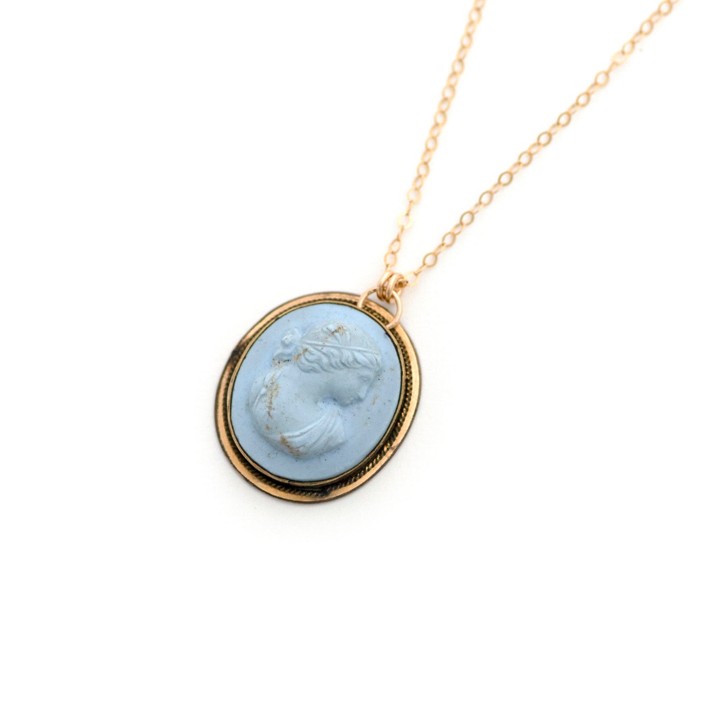 This antique conversion necklace is made up of:  Gold filled Victorian cuff link from the late 1800s with a pale blue porcelain cameo on a 14k gold filled chain.