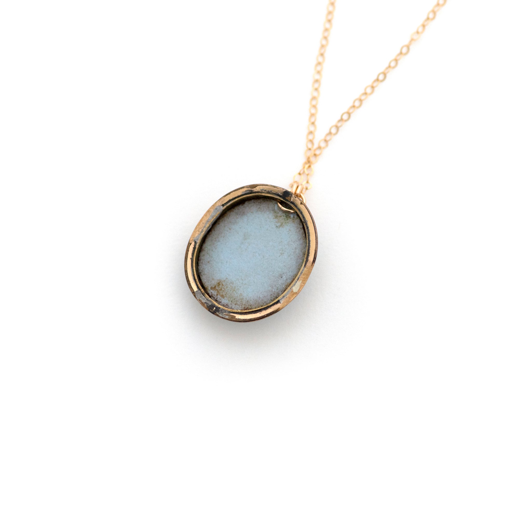The back of an antique conversion necklace is made up of:  Gold filled Victorian cuff link from the late 1800s with a pale blue porcelain cameo on a 14k gold filled chain.