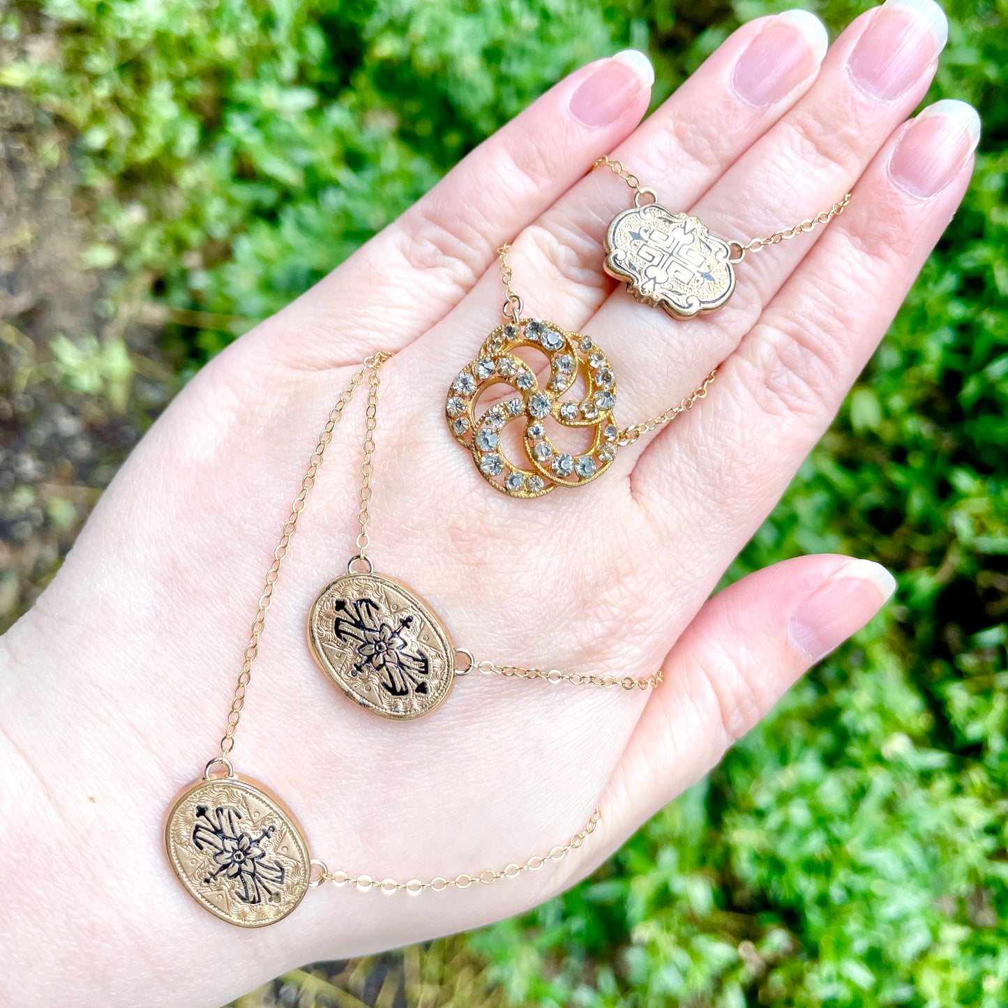 One rhinestone brooch conversion necklace and three gold filled Victorian cufflink conversion necklaces from the late 1800s with black enamel tracery (French = taille d'epargne).